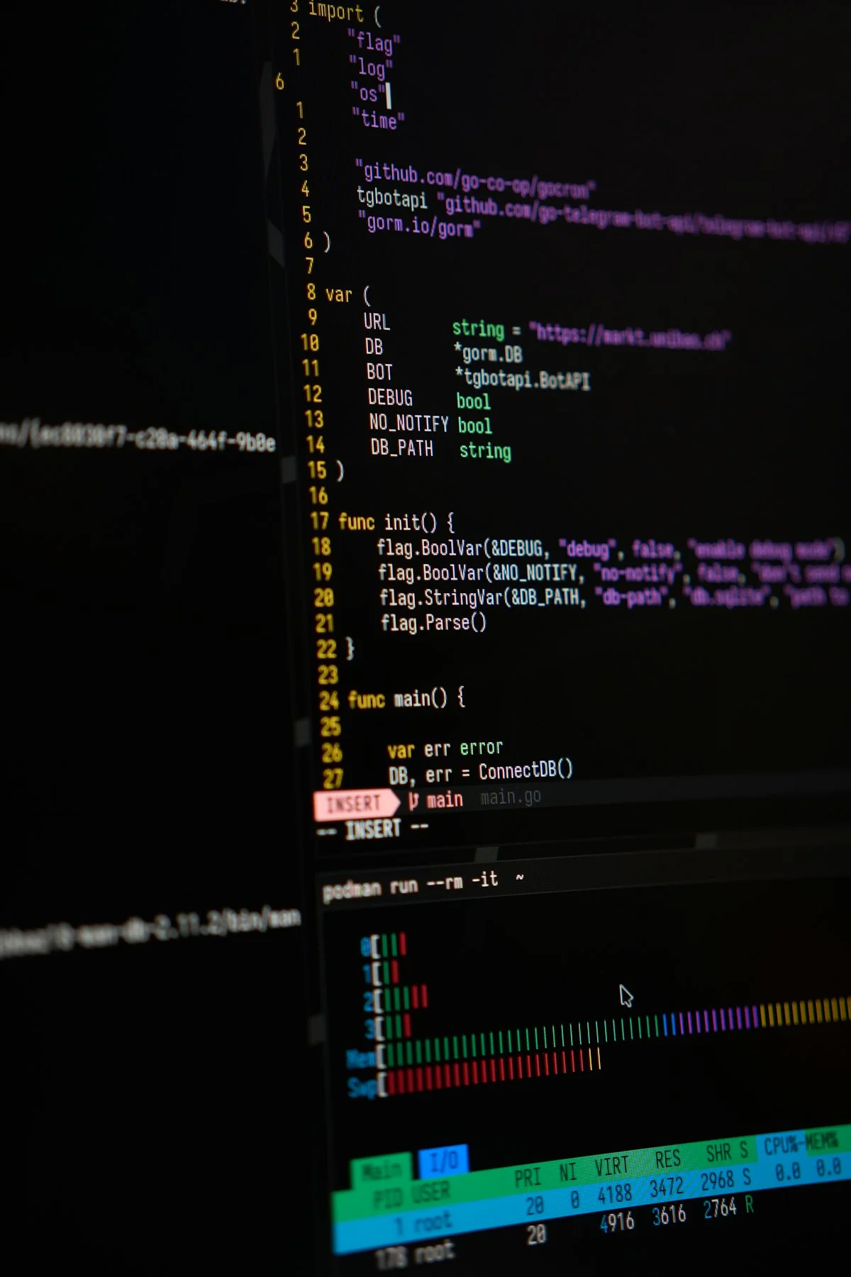 Computer screen showing code and system monitoring representing Linux development environment